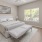 a bedroom with a bed, neutral decor and ceiling fan