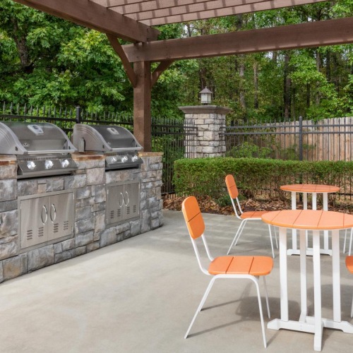 Everything within reach outdoor grilling area under pergola with seating