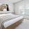 a bedroom with a large painting on the wall