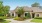 exterior of community clubhouse and leasing office with lush landscaping 